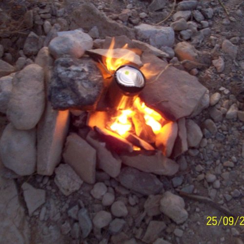 making a fire to cook some water in the desert