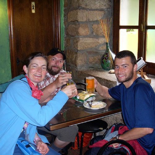 having a drink at the first bar after 100 km to santiago marker