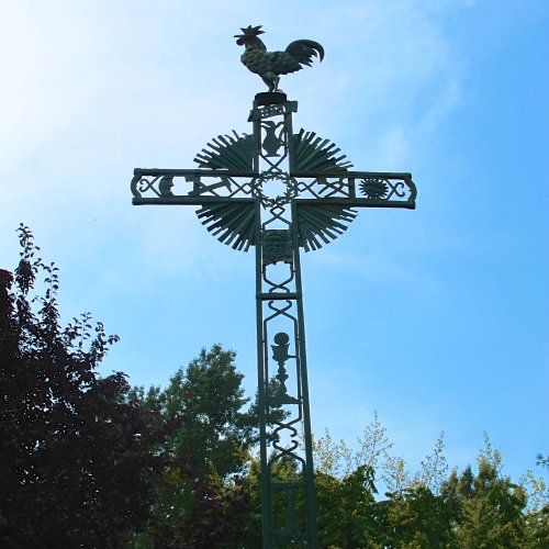 Turn right at the cross with the rooster.
